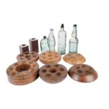 A collection of fruitwood tealight holders and four decorative glass bottles