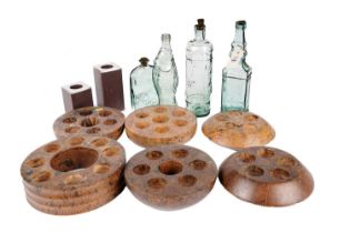 A collection of fruitwood tealight holders and four decorative glass bottles