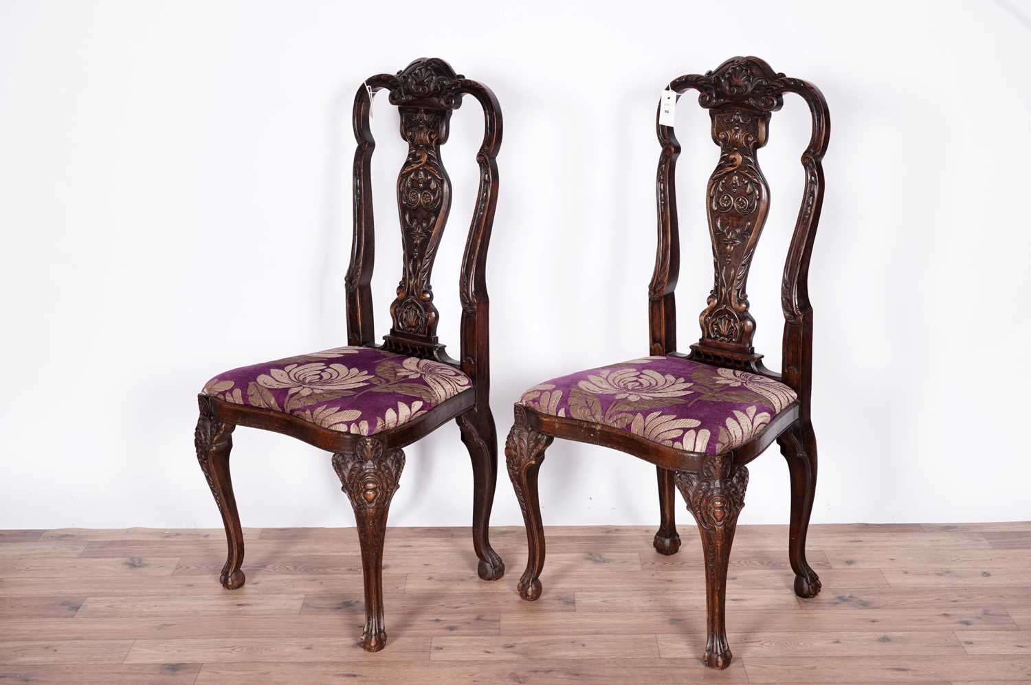 A pair of decorative mid 18th century style carved and stained beech side chairs
