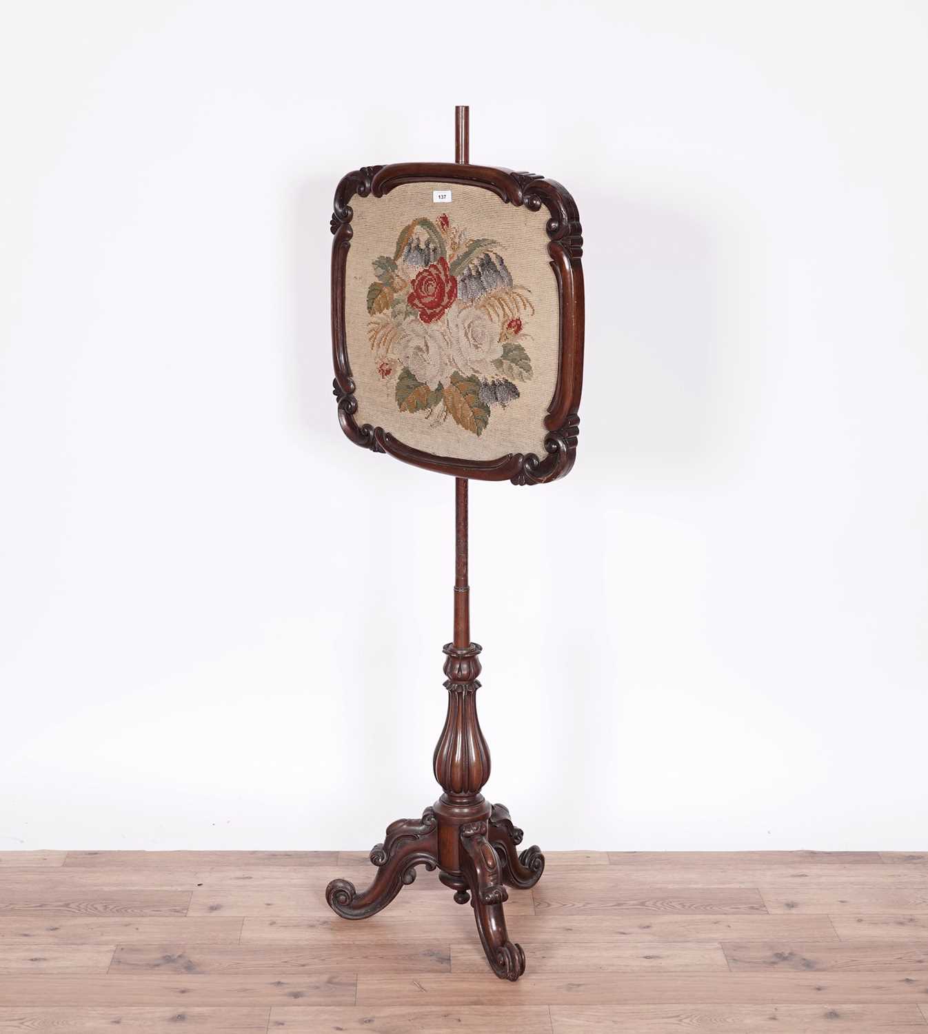 A Victorian carved mahogany needlework pole screen