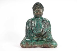 A stone composite garden figure of a seated Buddha