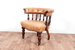 An early 20th century spindle back Library/Captains chair