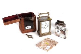 A carriage clock; two table lighters; and a pearl card case