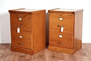 A pair of modern oak filing cabinets