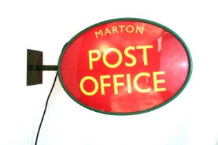 A double sided illuminated Post Office sign