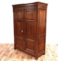 A large modern cherrywood two door armoire