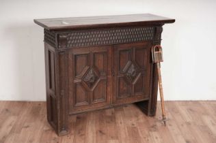 A Jacobean style carved oak cabinet