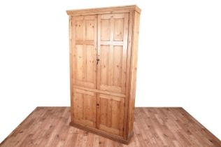 A large 20th Century stripped pine cupboard