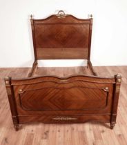 An ornate Louis XVI style mahogany double bed