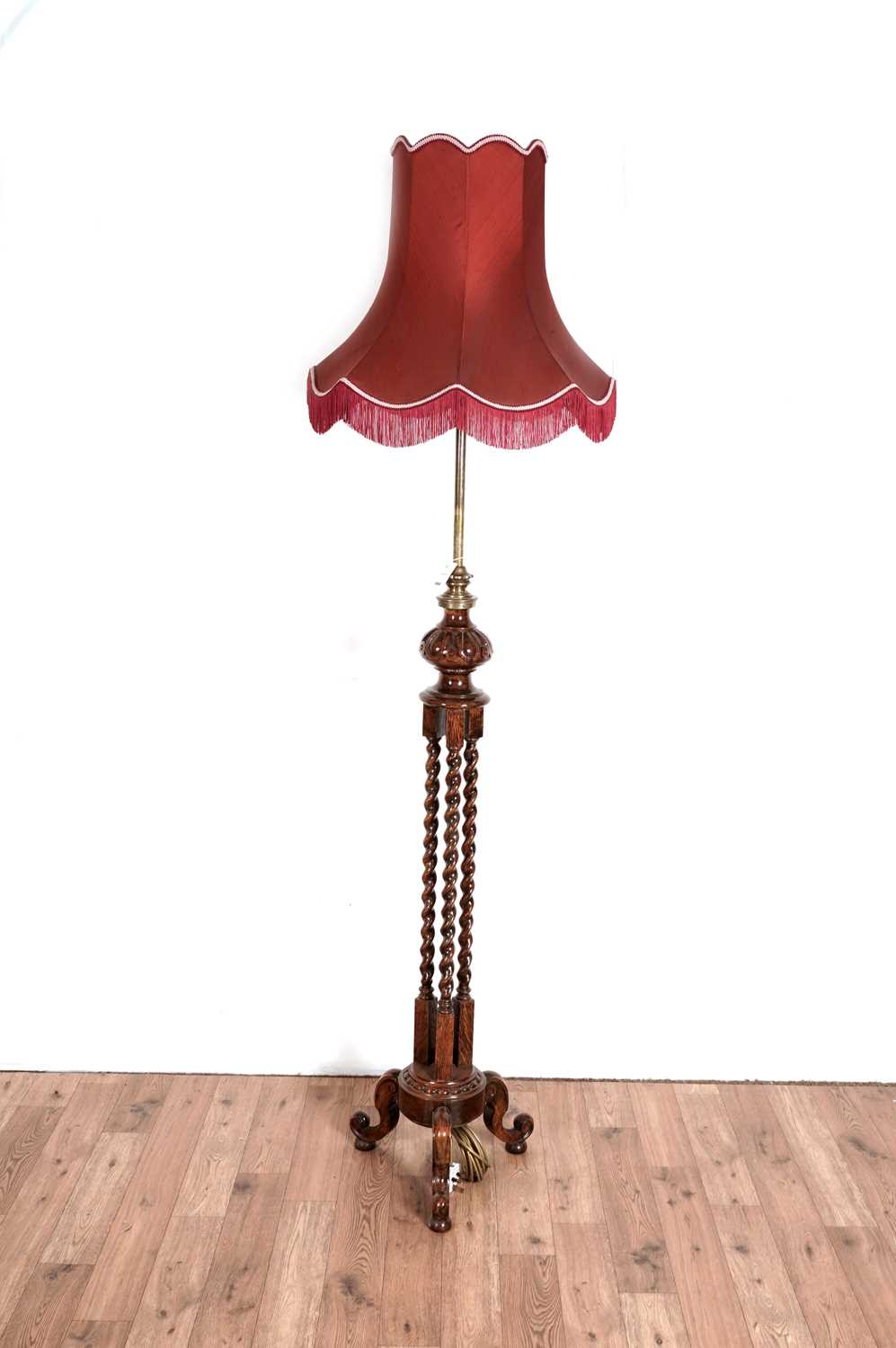 An early 20th Century oak and brass lamp standard