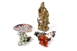 A 19th Century plate, Japanese wooden figure group and a selection of carved fruit