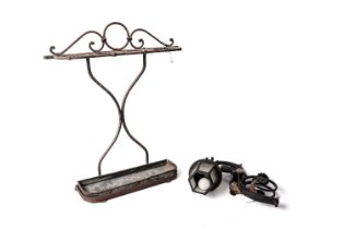 A vintage wrought iron stick stand and a cast iron lantern