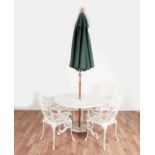 White painted circular garden table and four garden chairs with a parasol umbrella