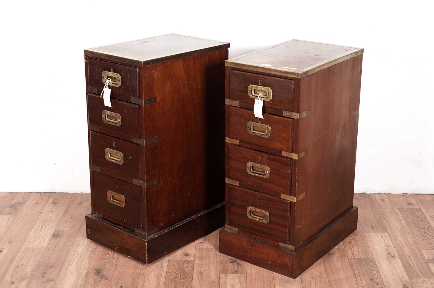 A pair of mahogany and brass bound bed side chests