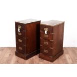 A pair of mahogany and brass bound bed side chests