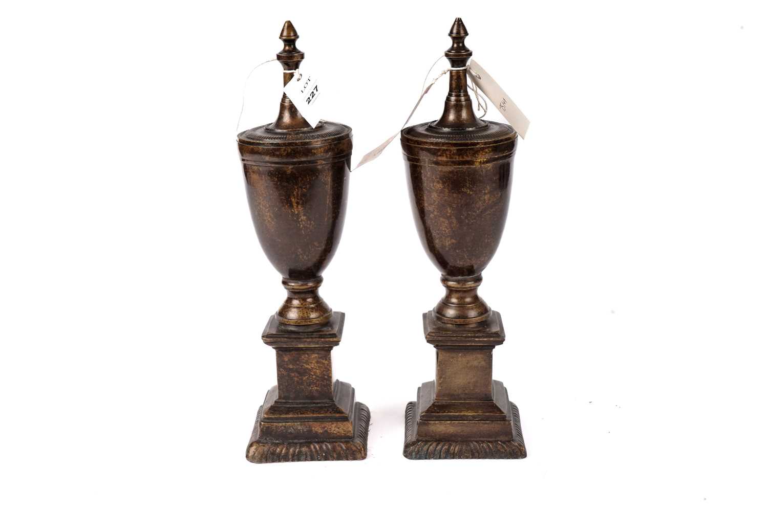 A pair of bronzed cast metal urns