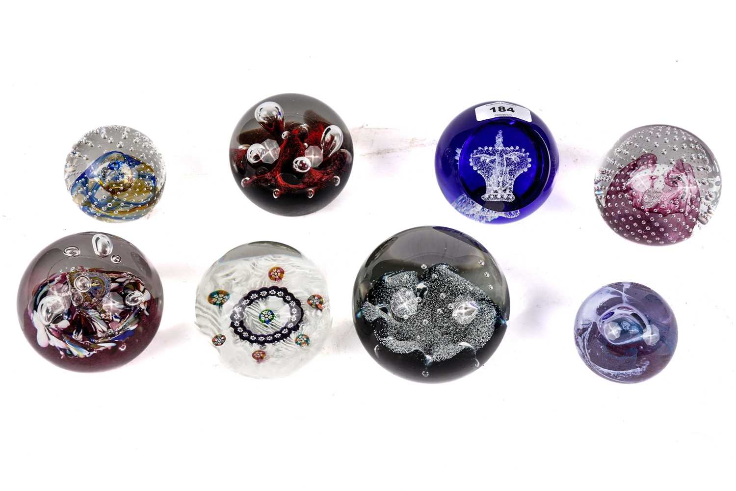 A collection of decorative glass paperweights