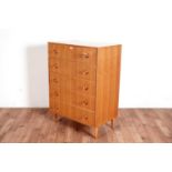 A mid Century oak veneered chest of five drawers