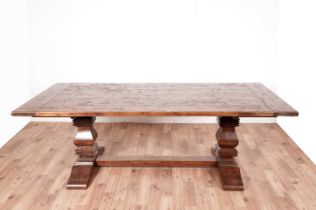 A substantial hardwood refectory dining table