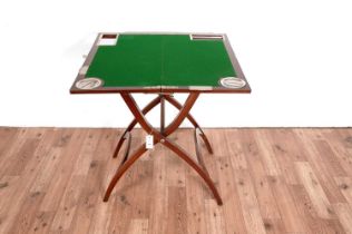 A mahogany folding campaign games/card table, in the manner of J. C. Vickery (London)