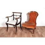 An early 19th Century carved and stained beechwood elbow chair and a Victorian walnut easy chair