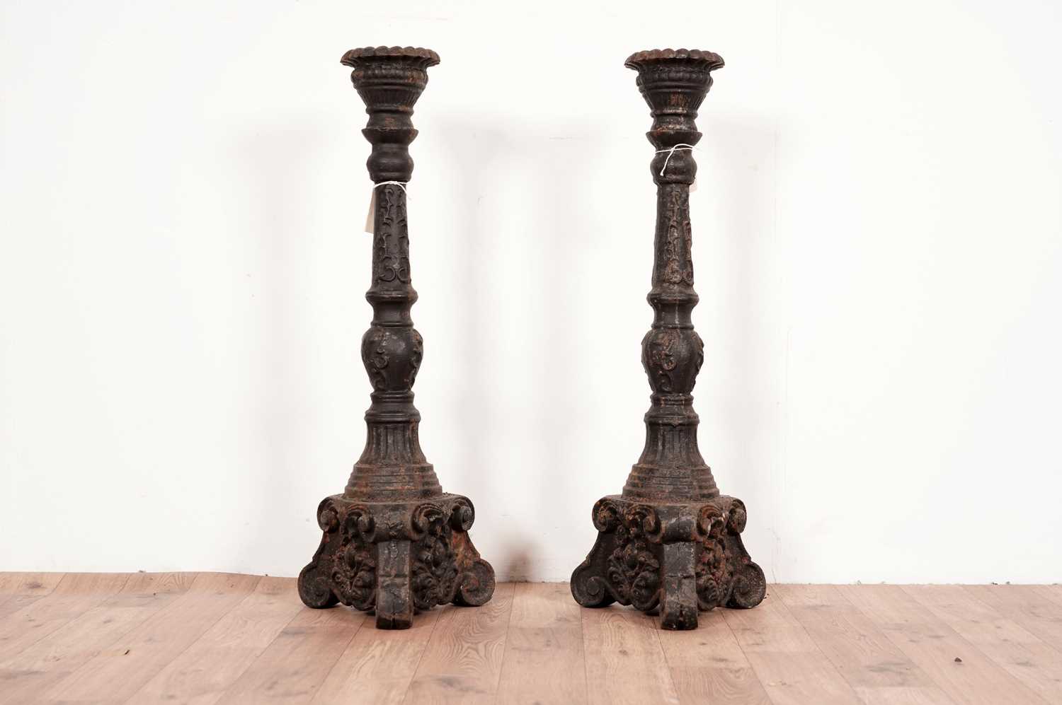 A pair of cast iron candlesticks