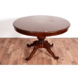 A mahogany and satinwood inlaid circular extending dining table