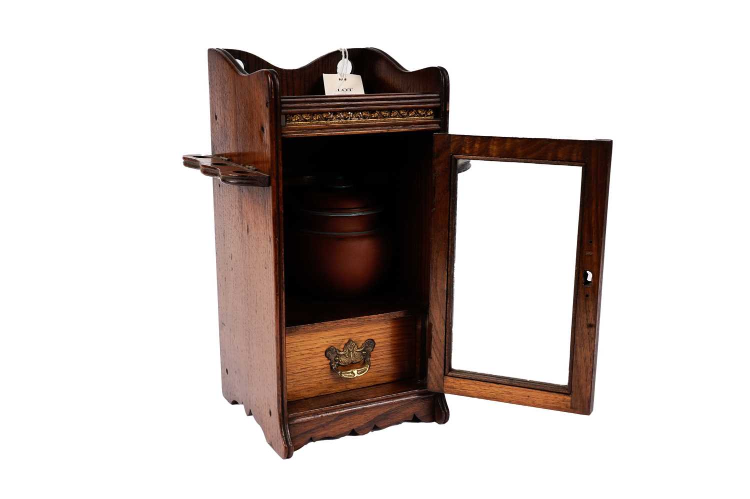 An Edwardian oak smokers cabinet