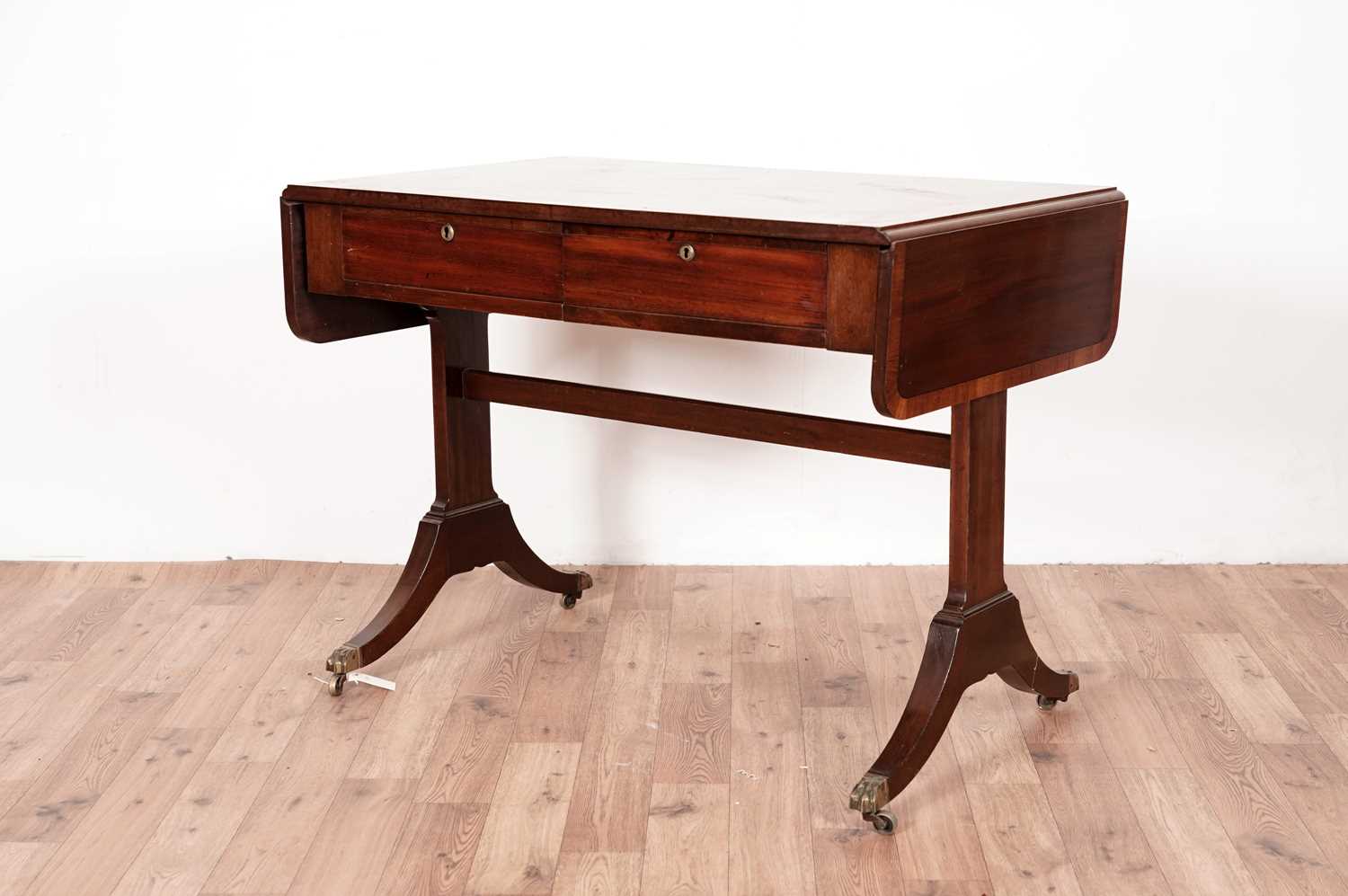 A Regency style mahogany and banded sofa table