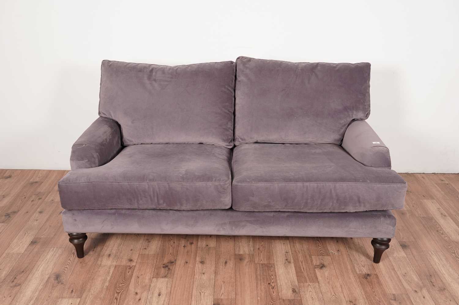 A grey two-seater sofa by The Lounge Co