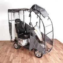 A Kymco Maxer mobility scooter with rain cover