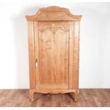 A modern carved pine wardrobe in the French style