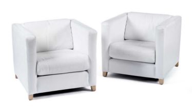A pair of modern white lounge chairs, of cuboid form
