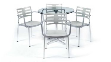 A contemporary chrome and glass tilt action table / Fritz Hansen - Ice dining chair by Kaspar Salto