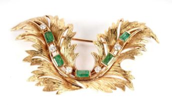 A gold, emerald and diamond brooch