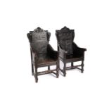 Two 19th Century carved and ebonised oak wainscot style chairs