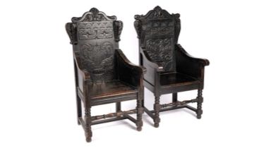Two 19th Century carved and ebonised oak wainscot style chairs