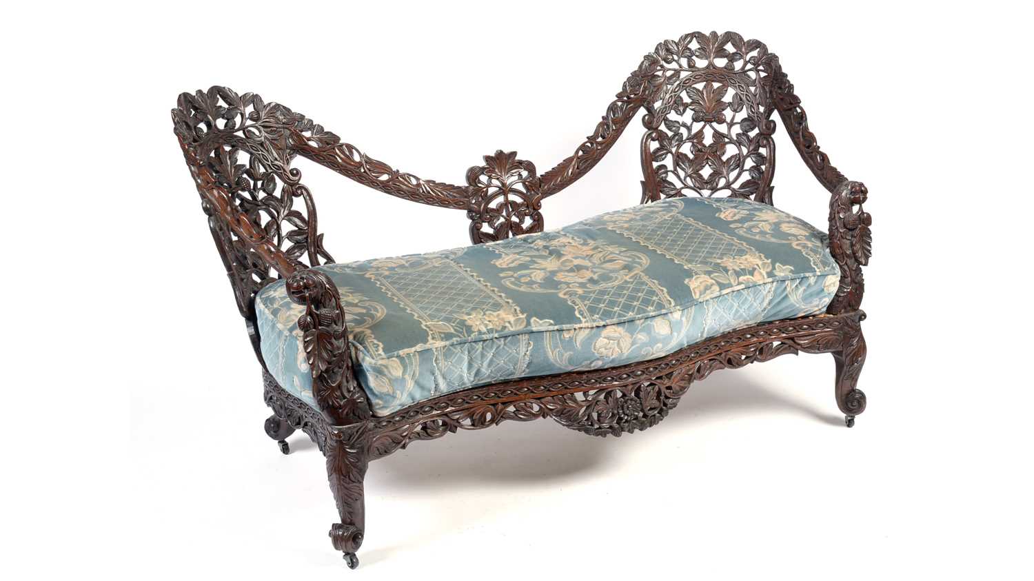 A decorative late 19th Century Anglo-Indian carved hardwood two seater sofa