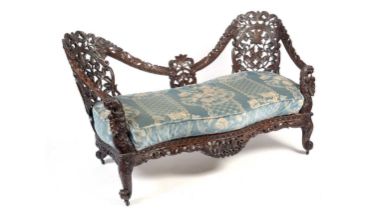 A decorative late 19th Century Anglo-Indian carved hardwood two seater sofa