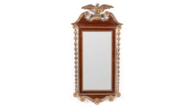 An American mahogany and gilt gesso parcel gilt wall mirror