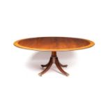 A William Tillman style mahogany and satinwood banded dining table in the Regency taste
