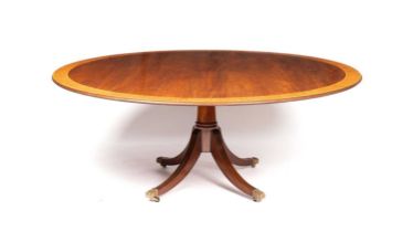 A William Tillman style mahogany and satinwood banded dining table in the Regency taste