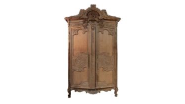 A large and impressive French provincial style carved light oak armoire