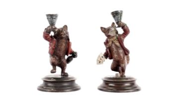 A pair of cold painted bronze candlesticks