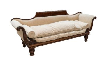 An early Victorian carved mahogany scroll end sofa