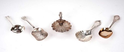 A Victorian silver Lily pattern caddy spoon; and four others