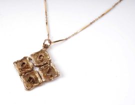 A gold pendant on chain