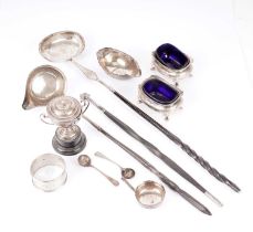 A selection of silver and white metal toddy ladles, napkin rings and condiments