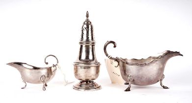 Two silver sauce boats and a silver sugar caster