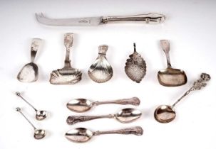 A selection of silver caddy spoons and other cutlery